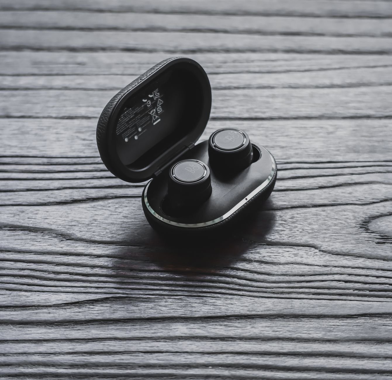 Earbuds and charging case resting on a table