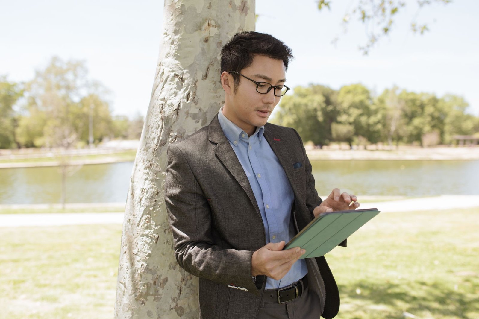 Person using a tablet-sized screen device outdoors