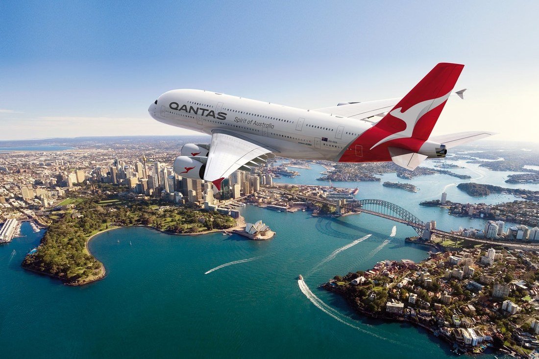 Qantas Airbus A380 flying above Sydney Harbour and the city skyline
