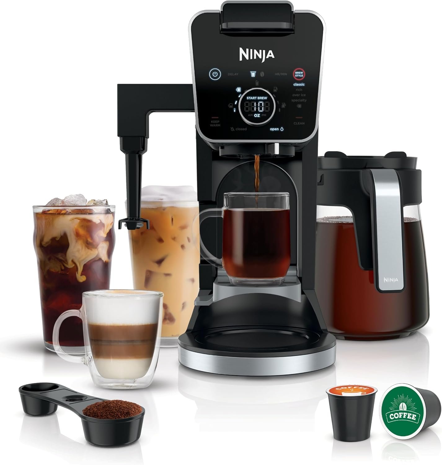 Ninja DualBrew Pro coffee maker in black with a carafe, pods and a travel mug beside it