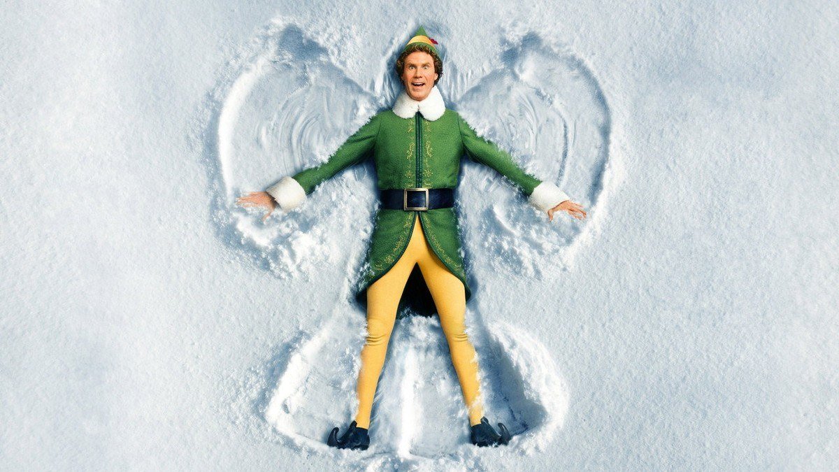 Elf key art with Will Ferrell as Buddy lying in the snow making a snow angel