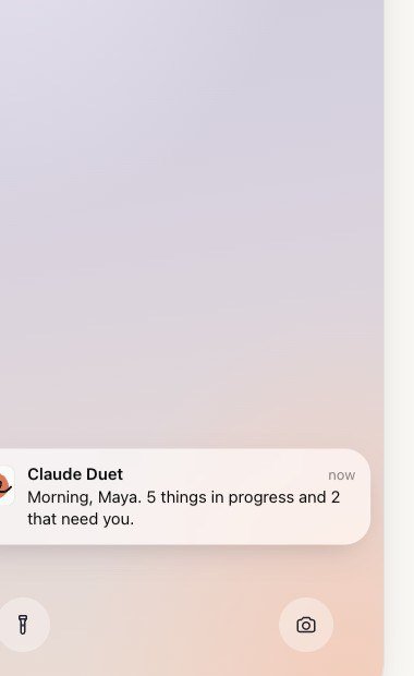 Phone lock screen showing a Claude Duet notification reading Morning, Maya, 5 things in progress and 2 that need you