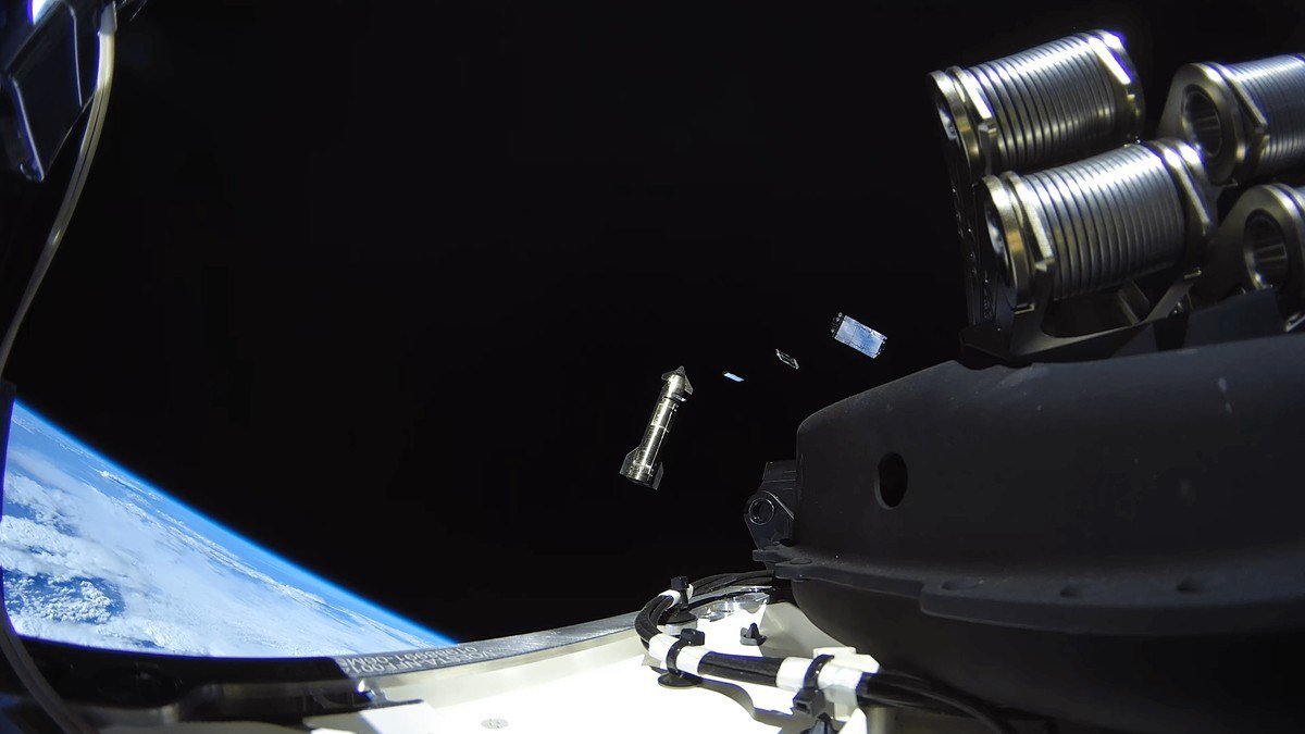 Camera view from a Starship in orbit with a deployed object drifting away above Earth's limb