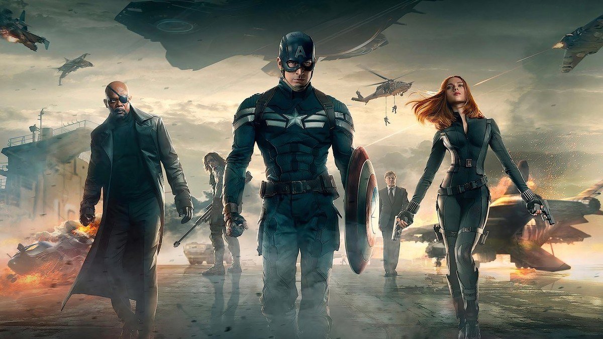 Captain America, Nick Fury and Black Widow walk away from a burning aircraft carrier