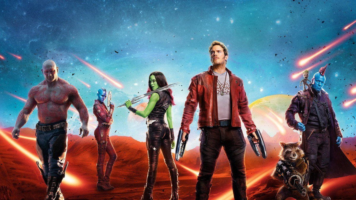 The Guardians walk across a red alien landscape under streaking fire