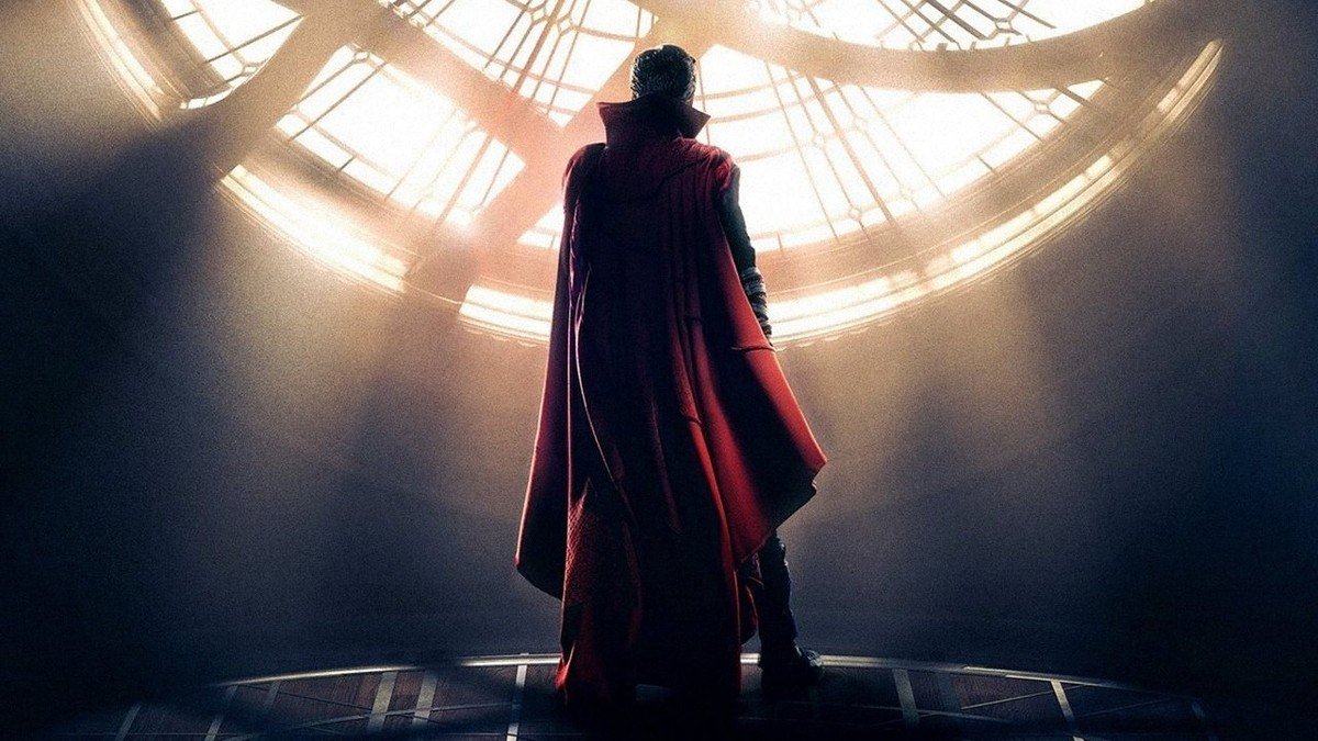 Doctor Strange stands with his back turned beneath the round window of the Sanctum