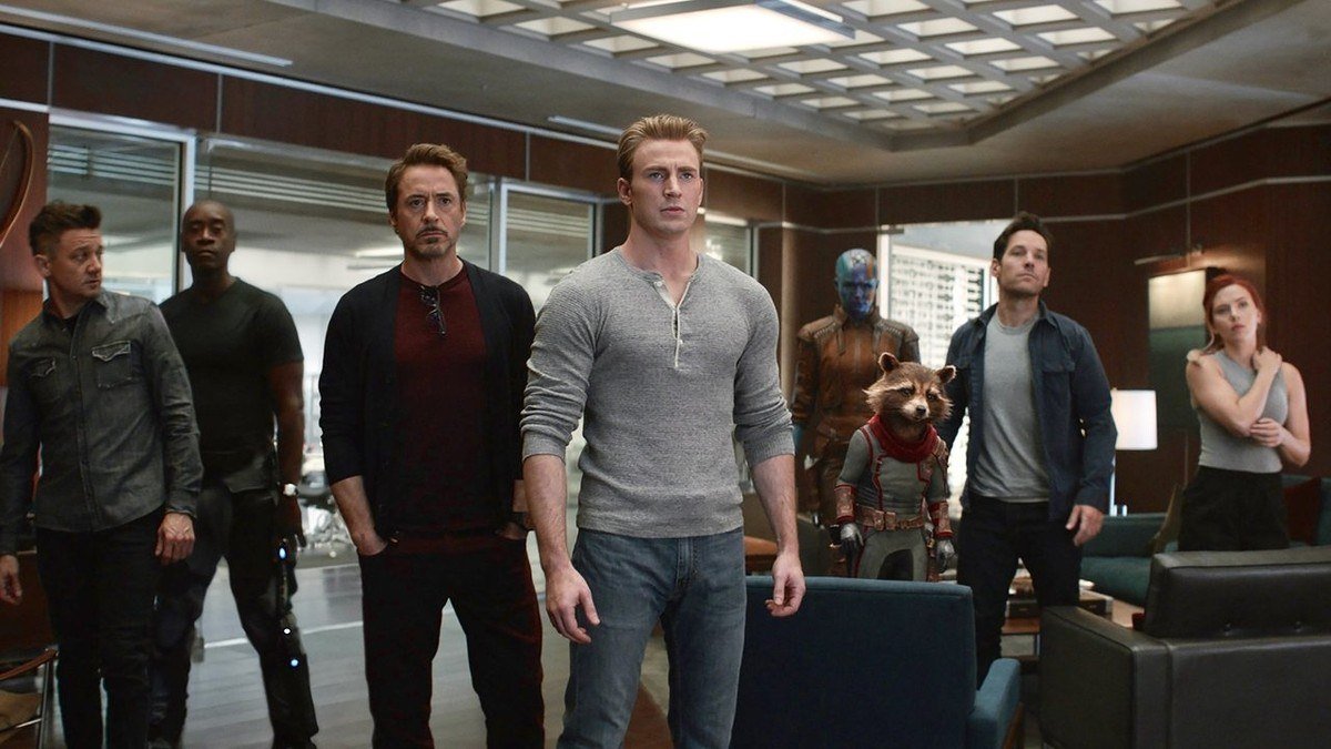 The surviving Avengers stand together in a glass-walled office at the compound