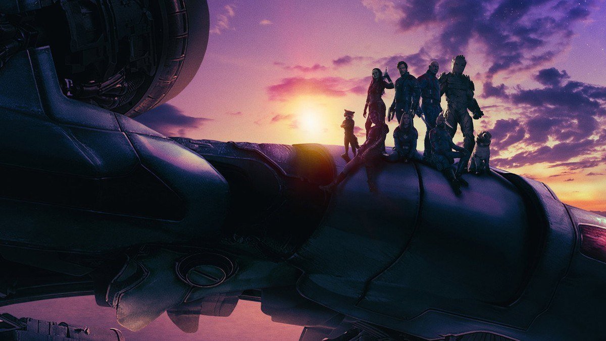 The Guardians stand in silhouette on top of their ship at sunset