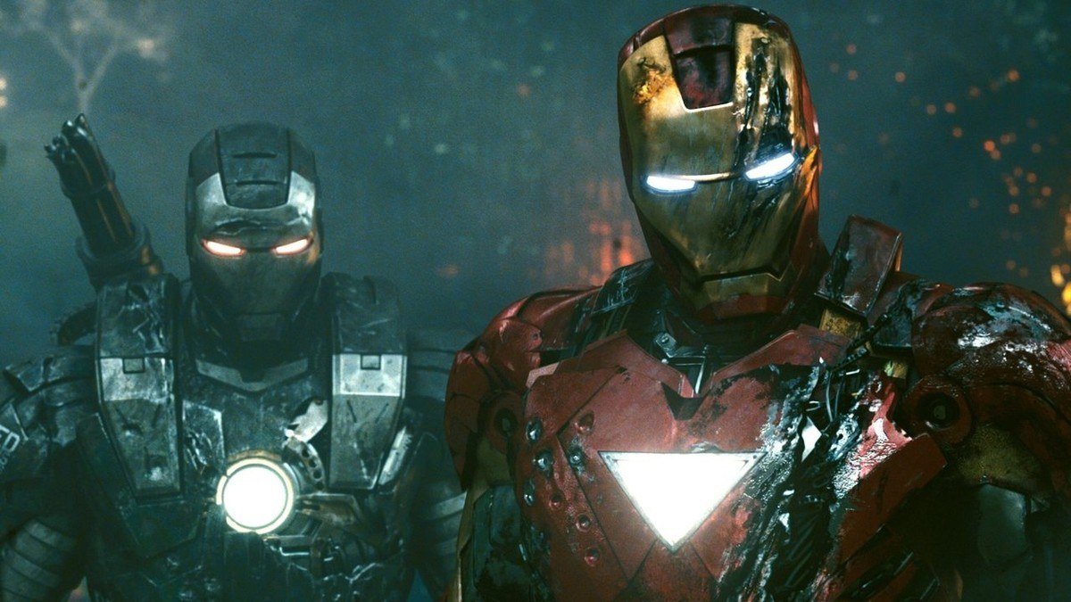 Iron Man and War Machine stand side by side in a dark hangar