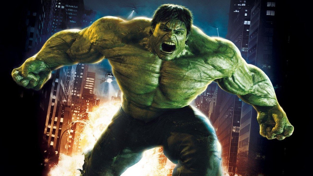 The green Hulk roars with fists clenched in a city street at night