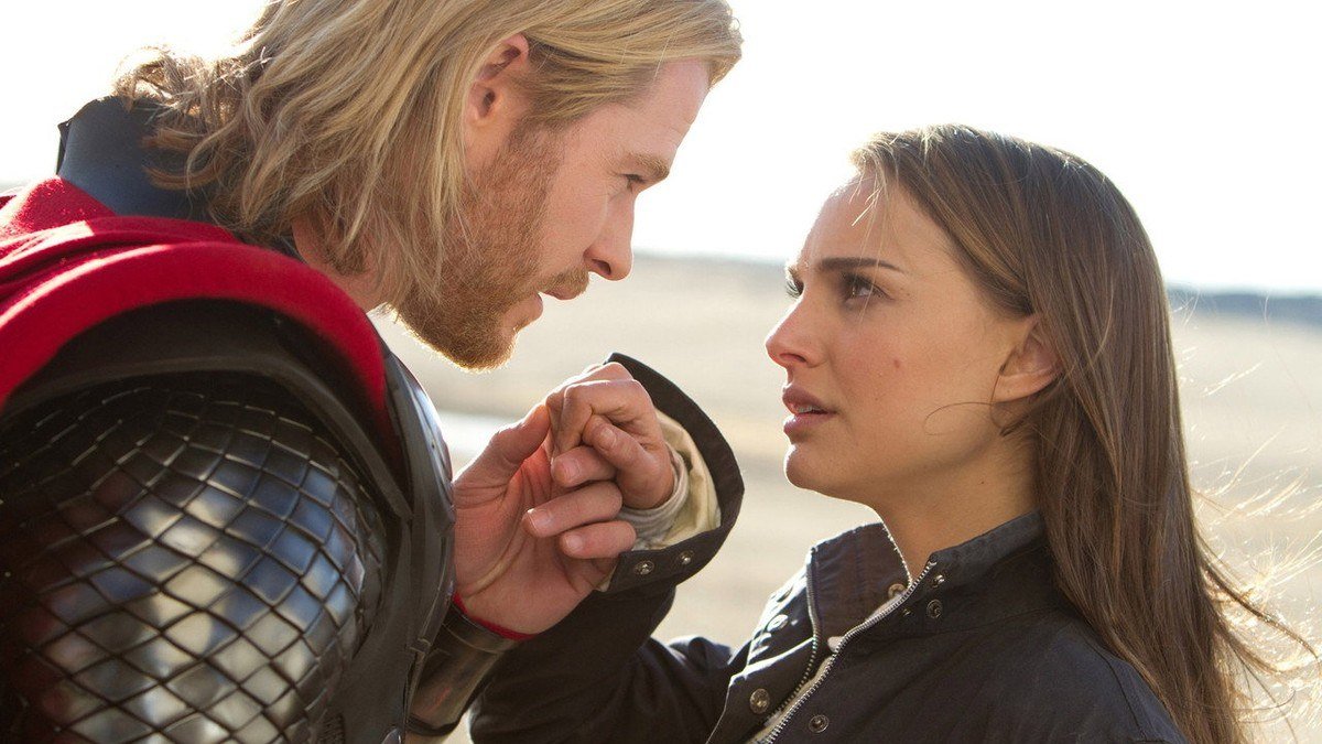 Thor kisses Jane's hand in a windswept desert