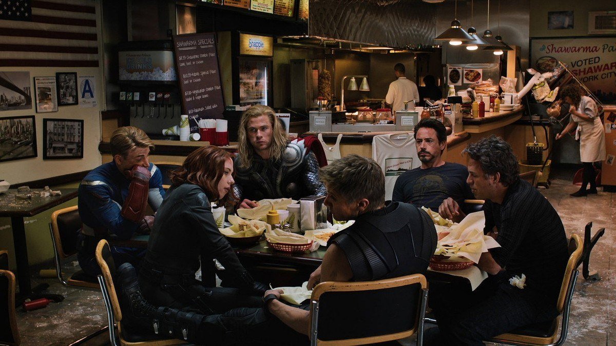 The Avengers eat in silence at a battered shawarma restaurant after the battle