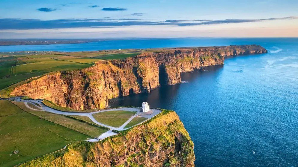Aerial sunrise view of the Cliffs of Moher with O'Brien's Tower and the coastal path