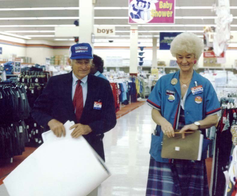 Sam Walton talking with Walmart associates in a store